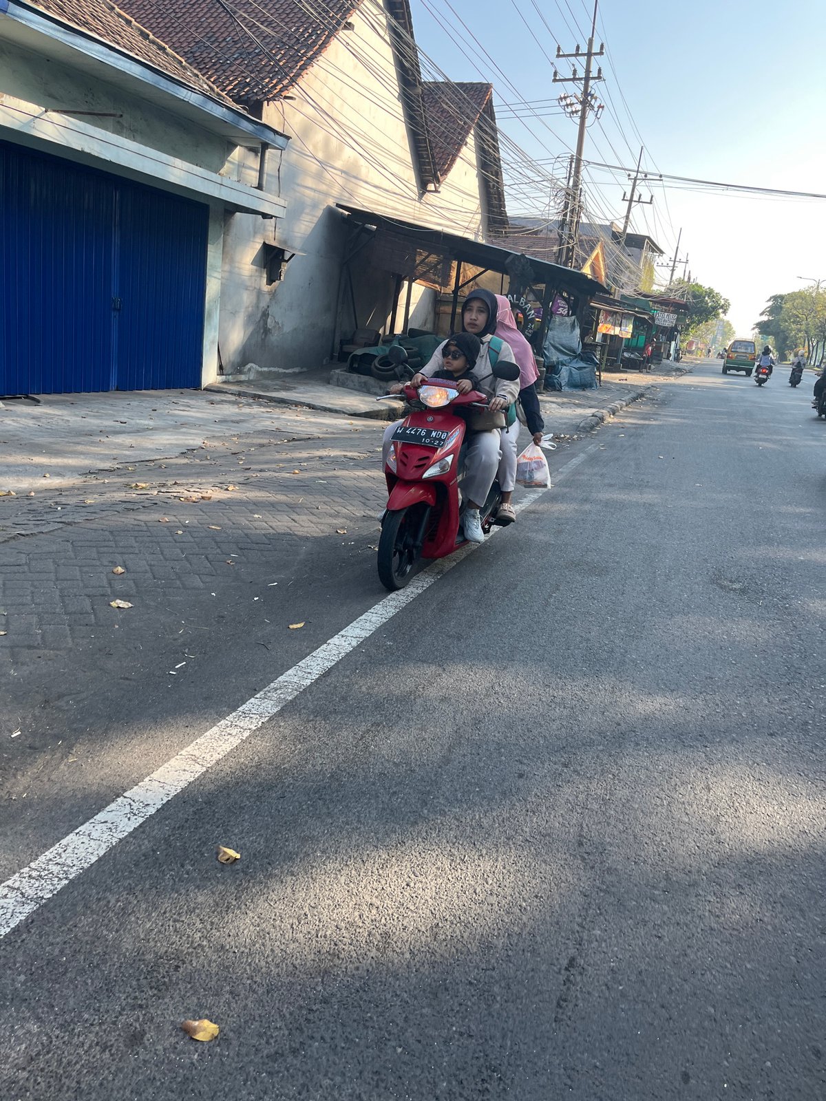 Morning street life along a busy road in Kludan, Indonesia