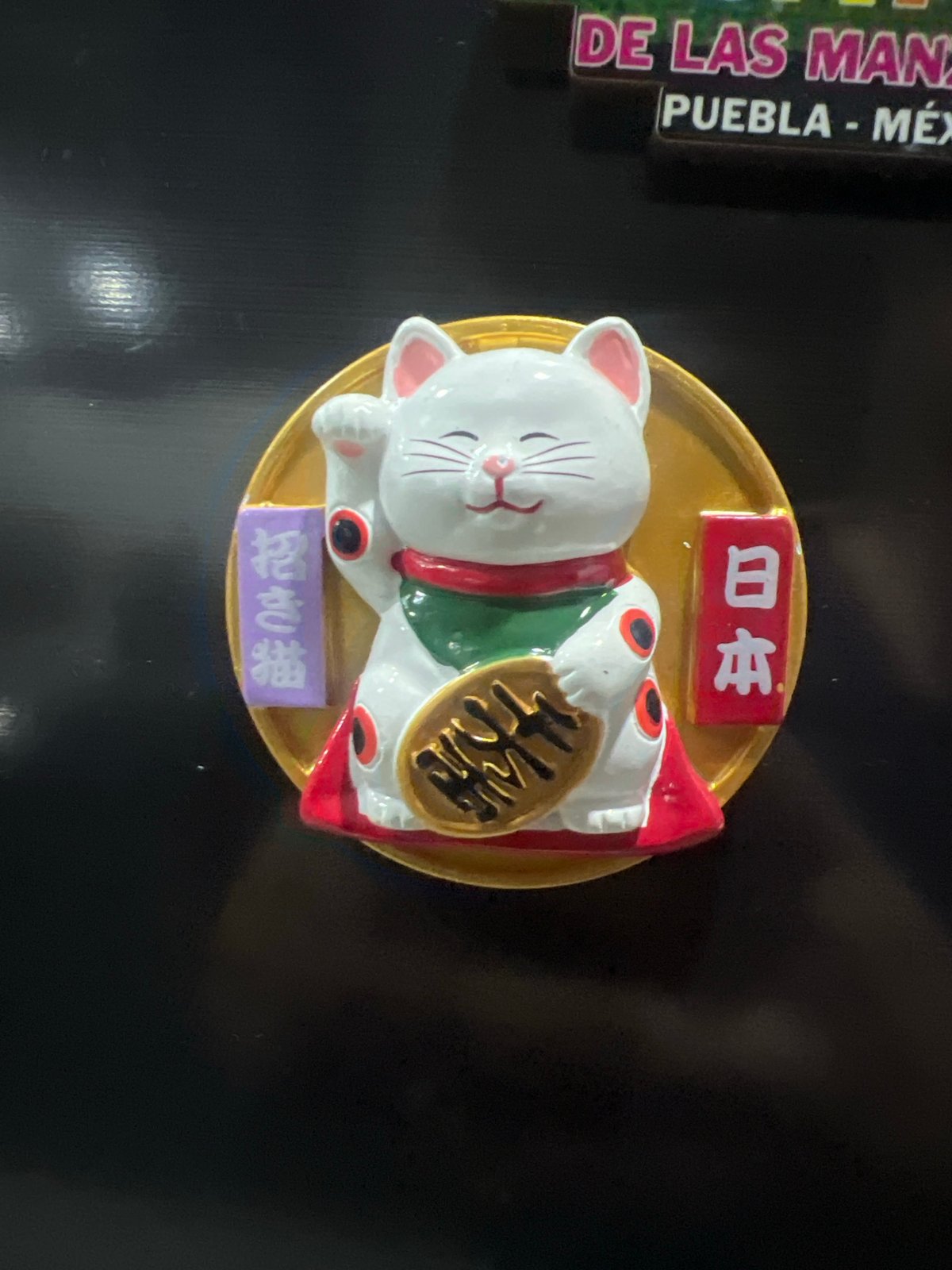 Evening scenes captured in Cholula: lucky cat figurine, sunset