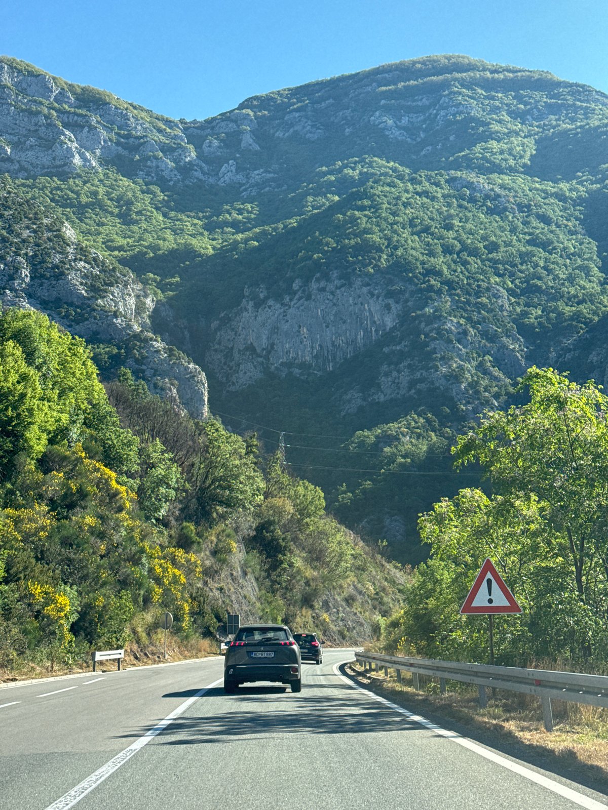 Vehicle travels mountain road in Mišići, Montenegro
