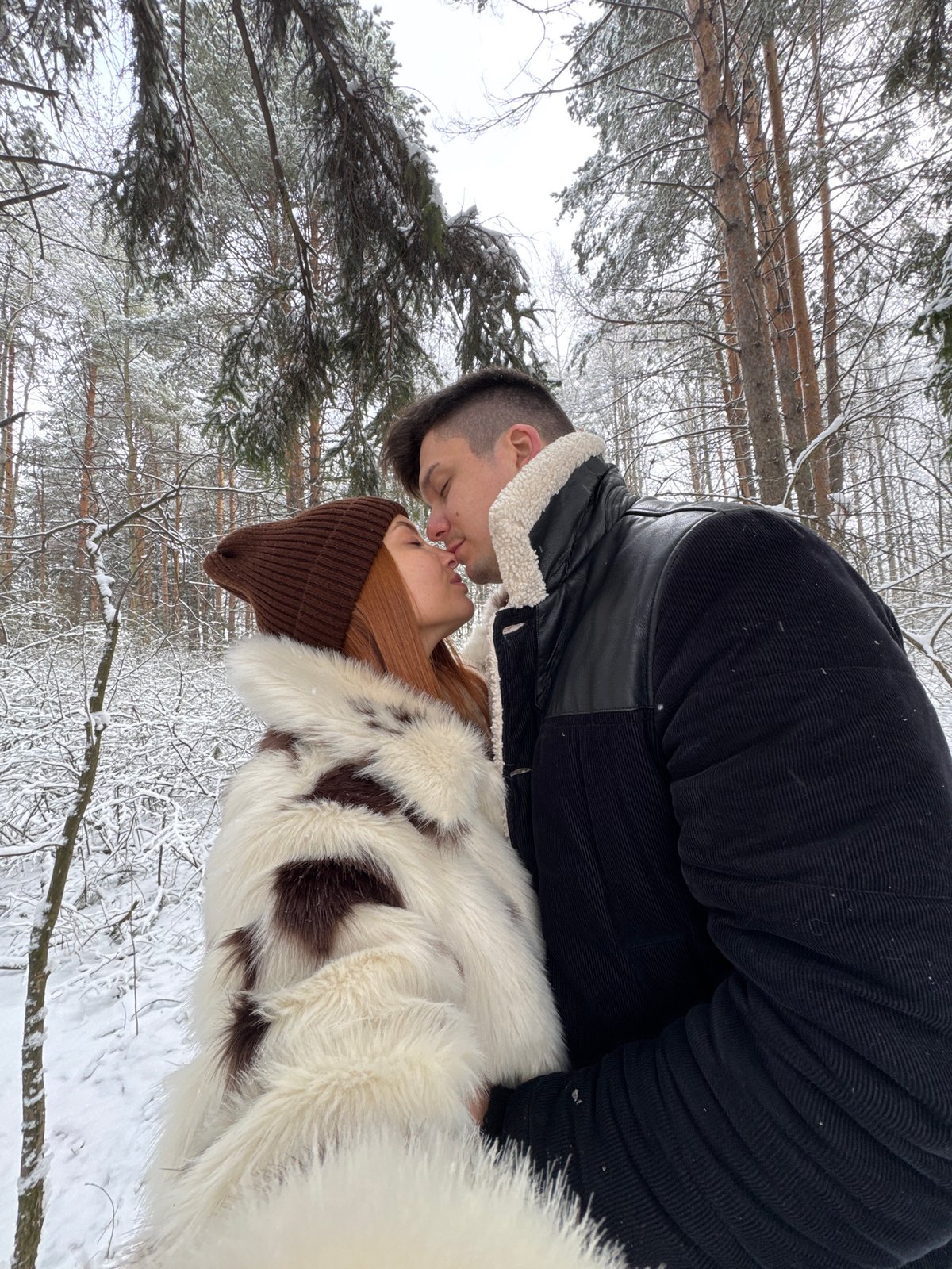 Couple shares intimate moment in snowy Chaikovsky forest