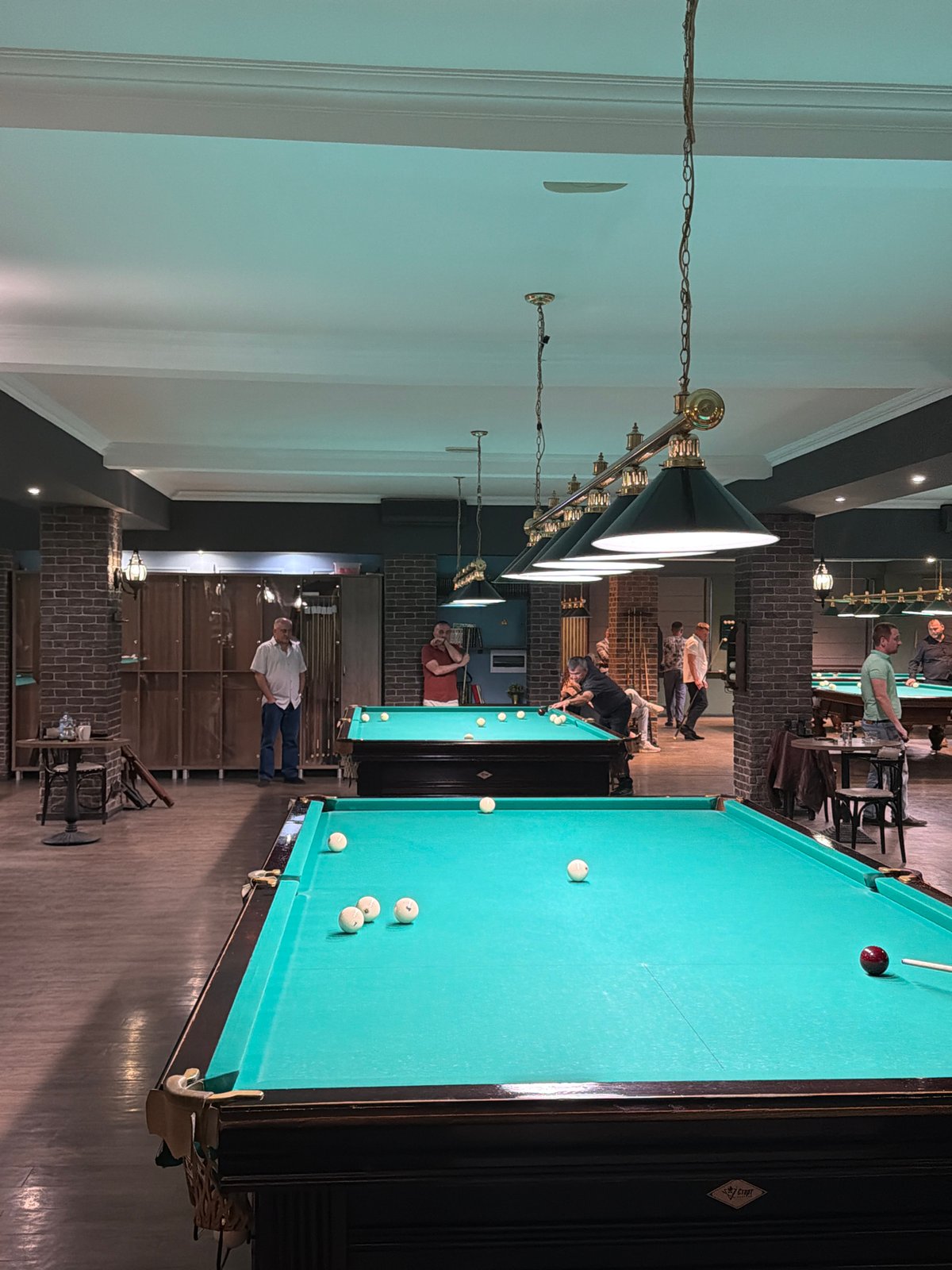 Man plays billiards at Izhevsk hall during afternoon session