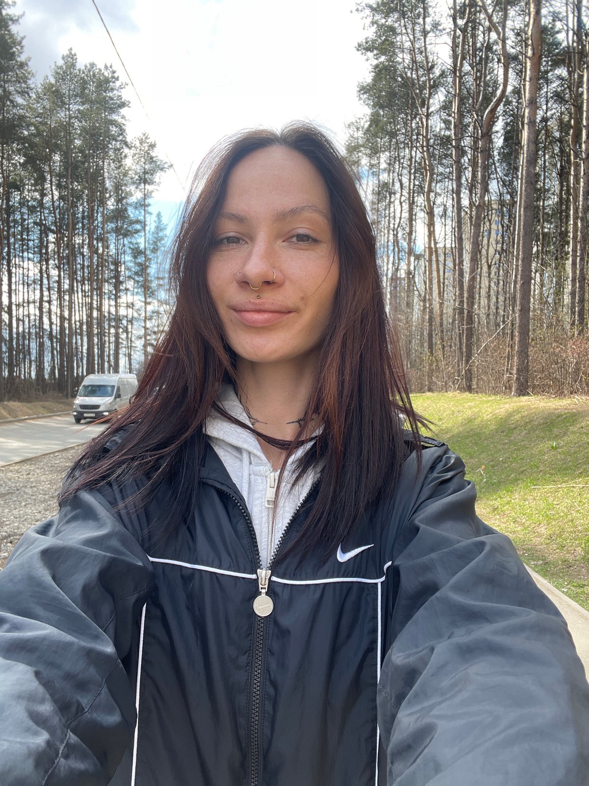 Woman takes selfie under partly cloudy skies in Izhevsk