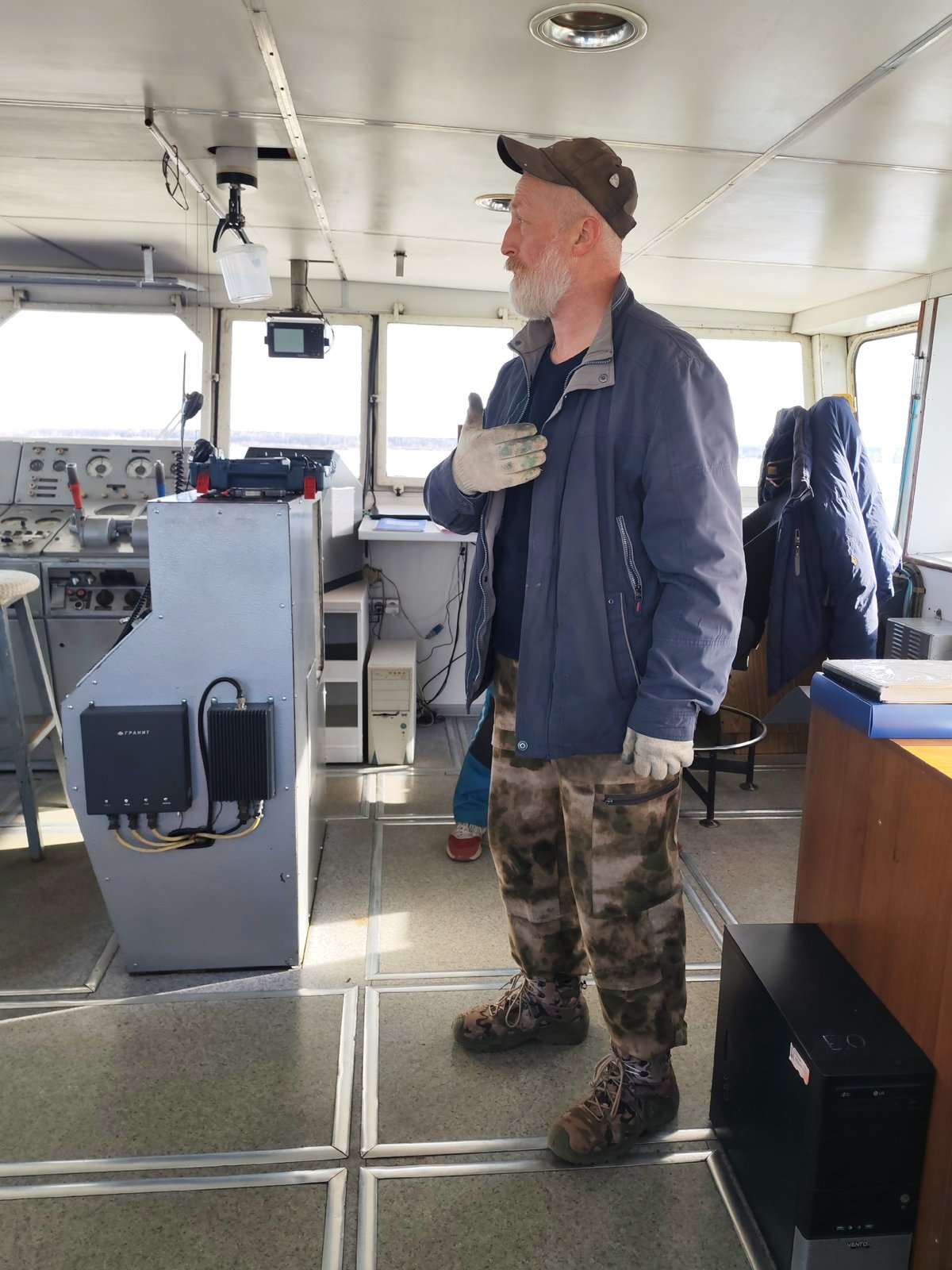 Bearded captain observed in ship's pilothouse