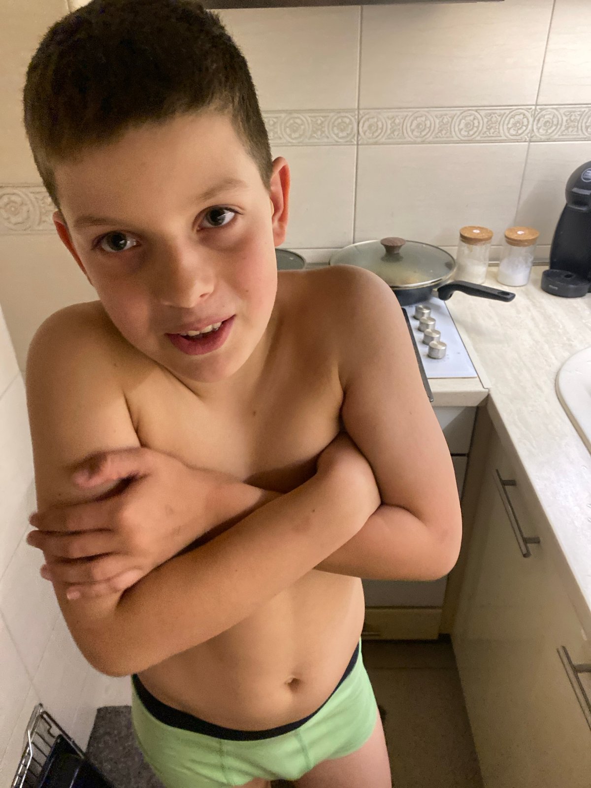 Boy drinks, plays with kitchen items in Budva home