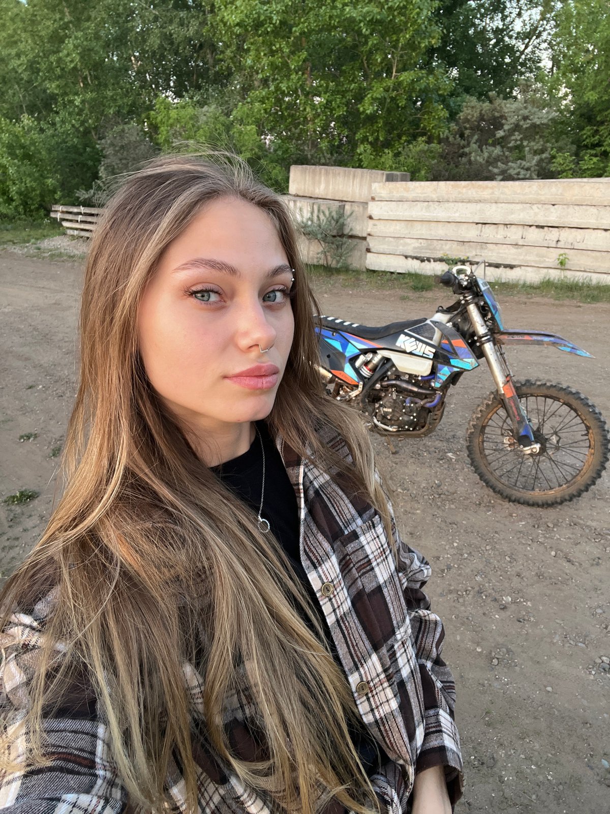 Couple with dirt bike photographed near Chaikovsky, Russia