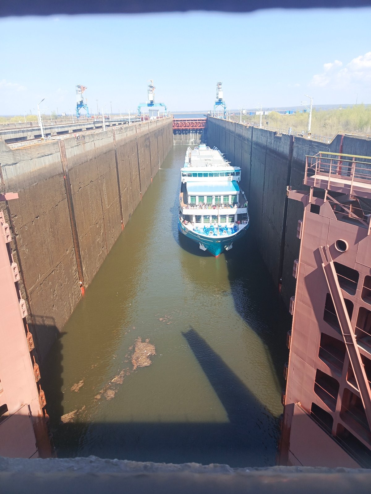Cruise ship transits canal lock with passengers aboard