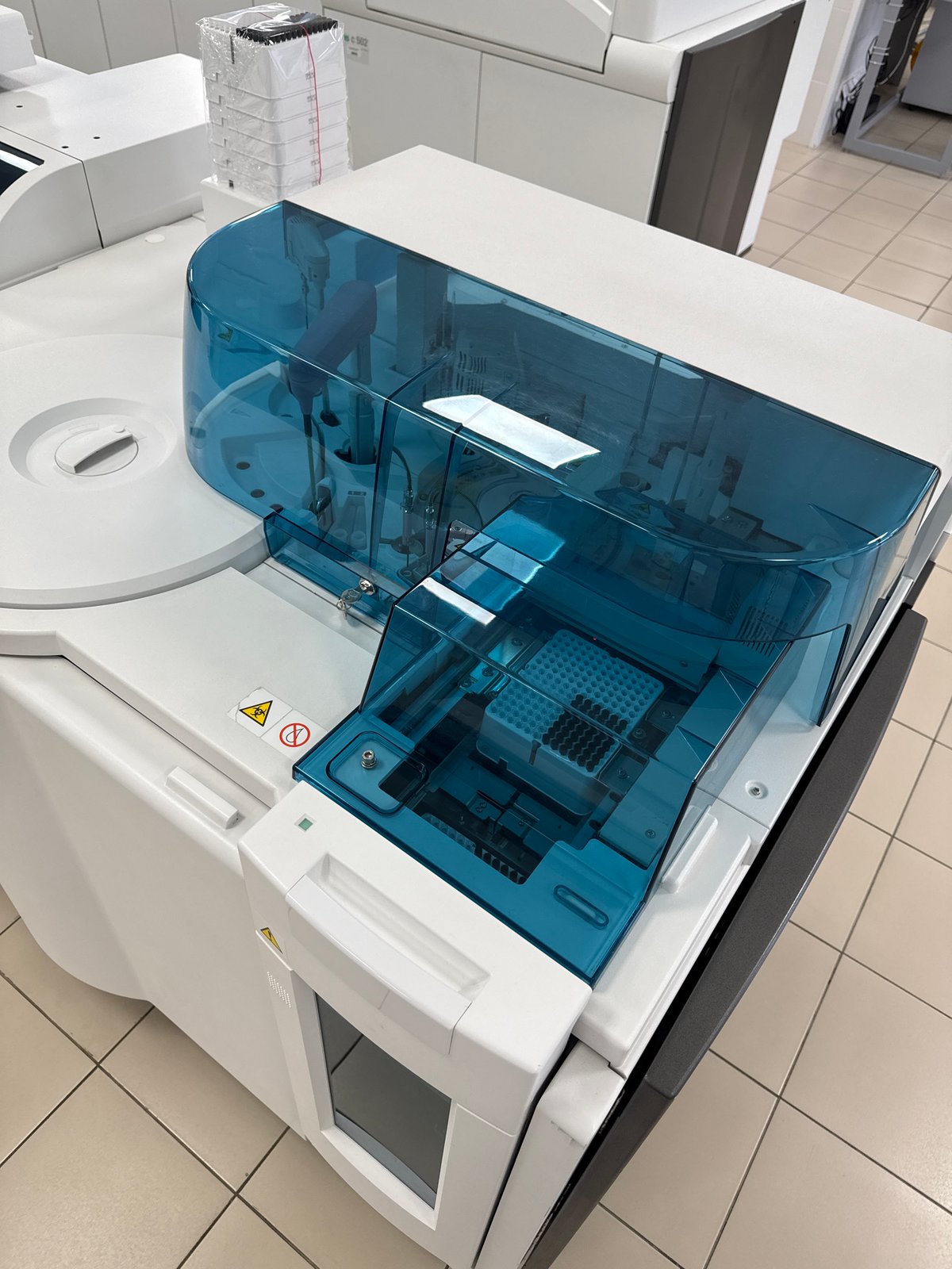Medical analyzer with biohazard symbol observed on laboratory floor