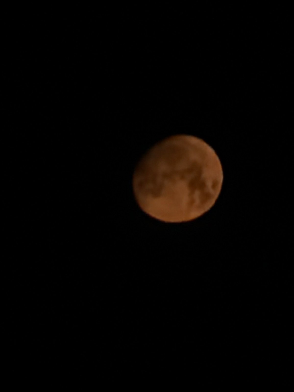 Reddish moon photographed over Wrocław on a summer night