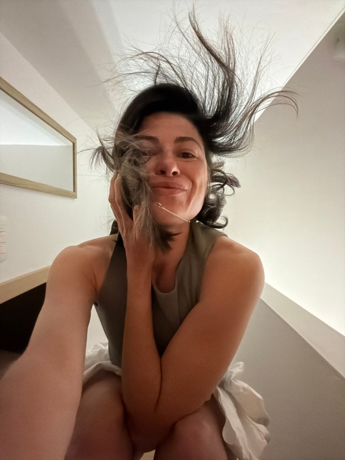 Woman photographs herself in bedroom in Budva, Montenegro