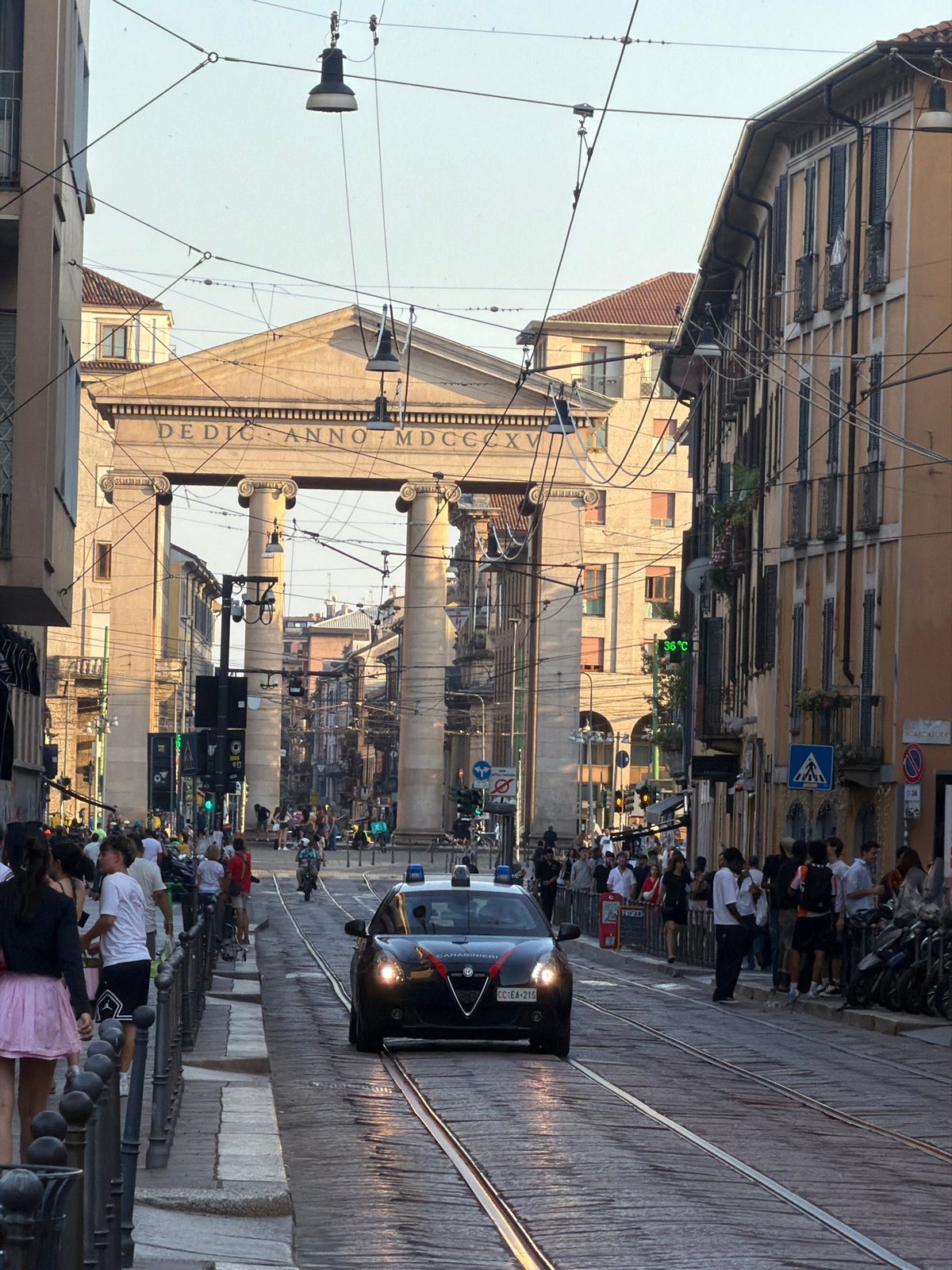 Milan street afternoon: shops, Vespas, and urban details