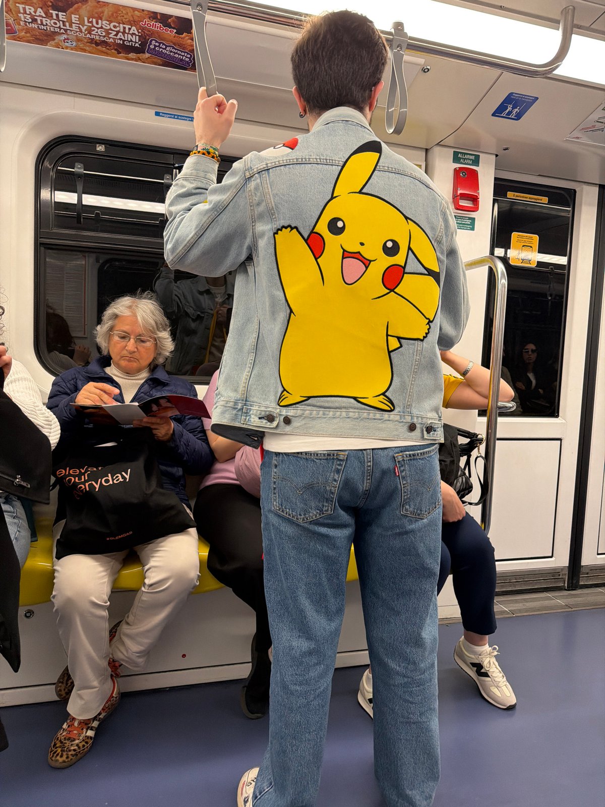 Crowded metro car observed during midday transit in Milan