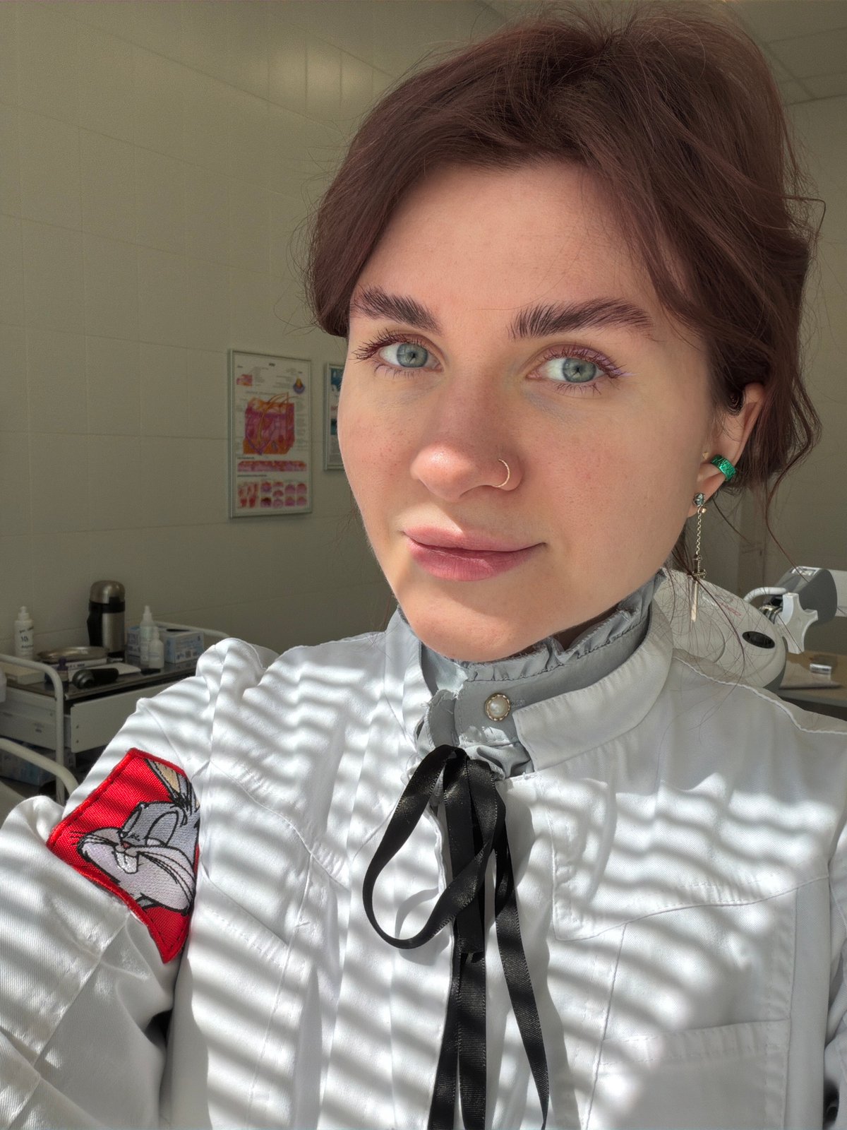 Lab coat-wearing individual observed in Khimki interior setting