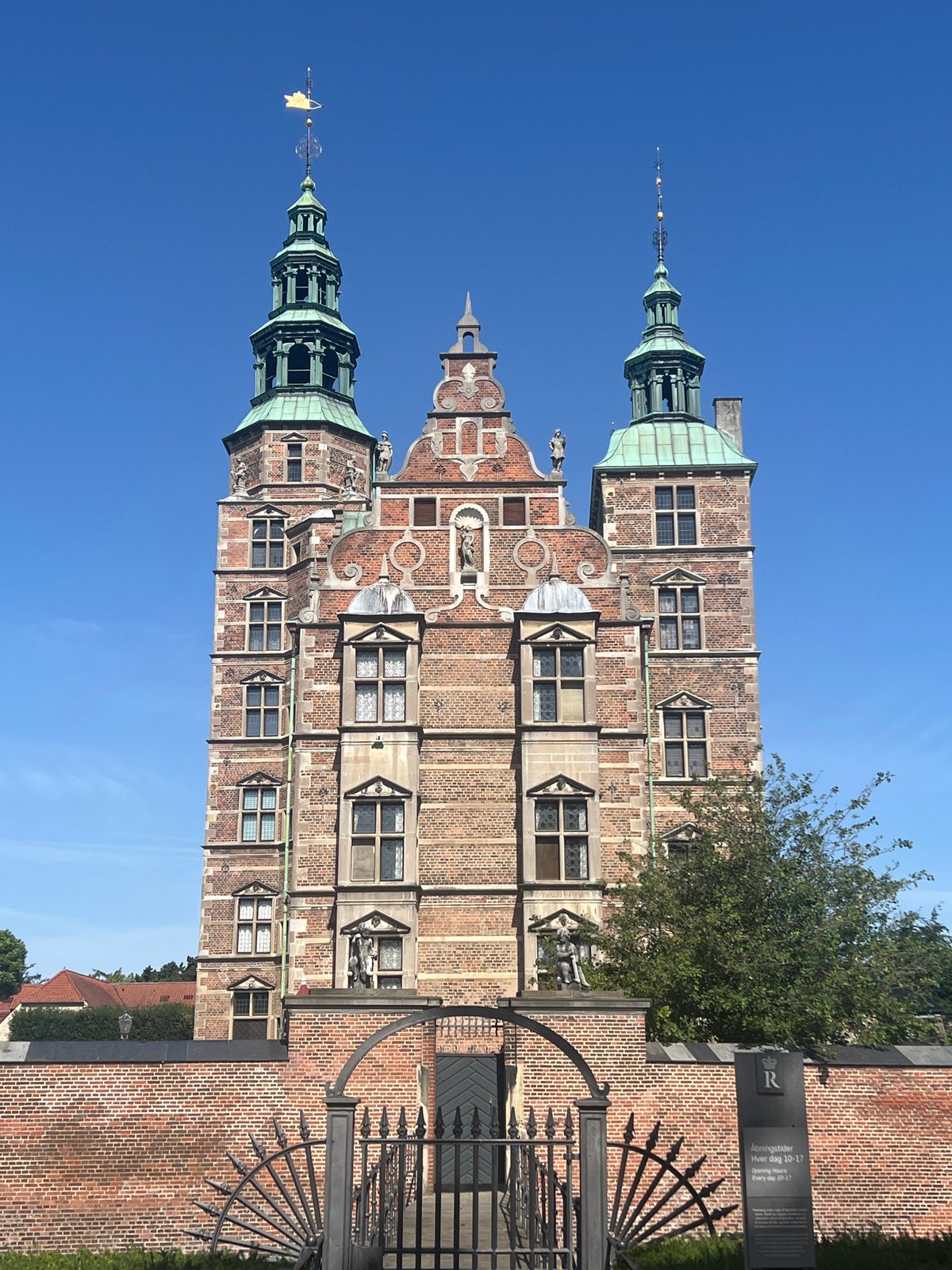 Geese roam the grounds of Rosenborg Castle on a summer morning