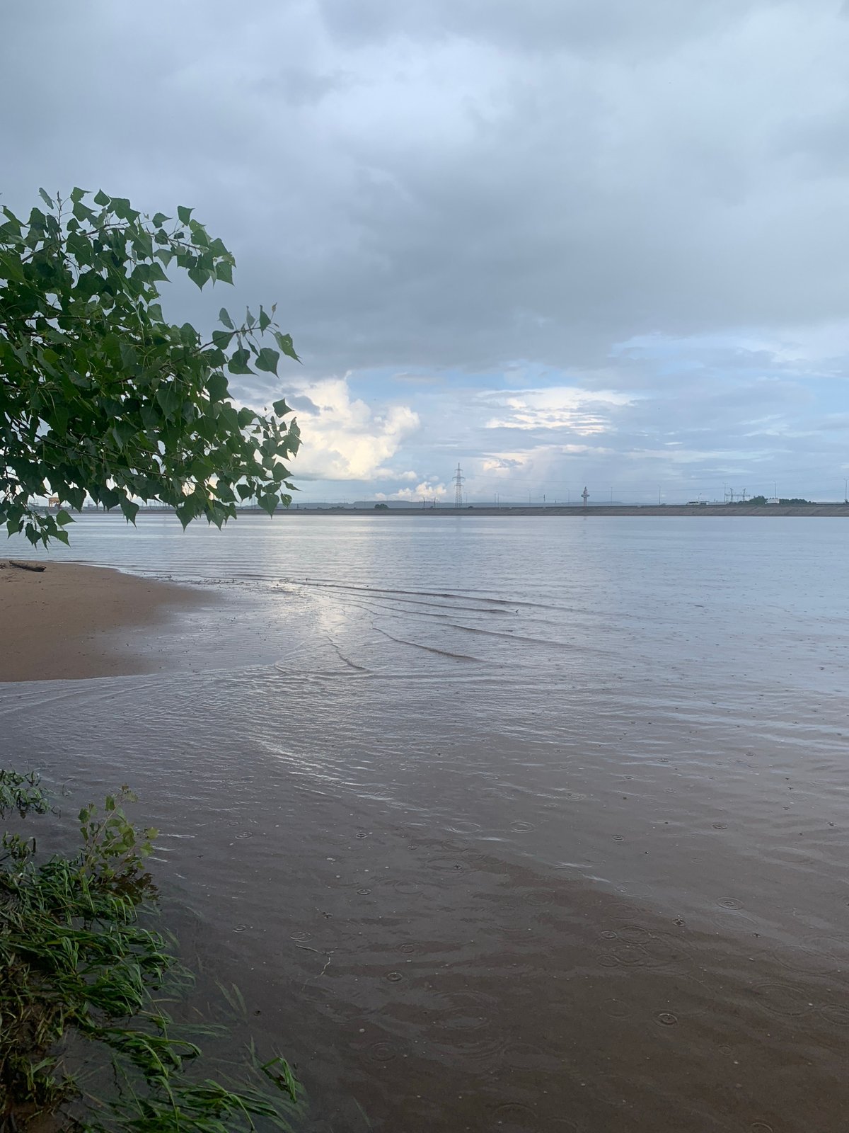 Family barbecue gathering by Russian waterside despite rainy weather