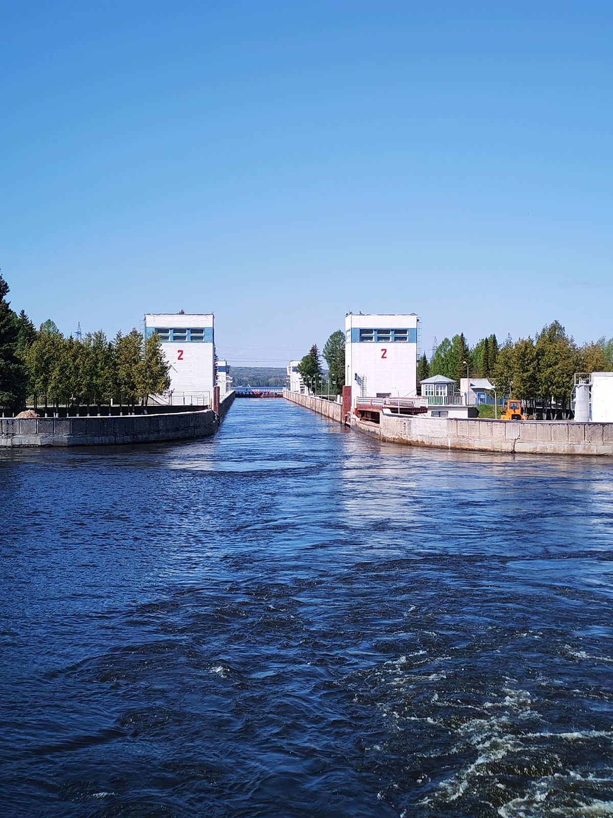 Freighter transits canal lock in Белоусово, Russia
