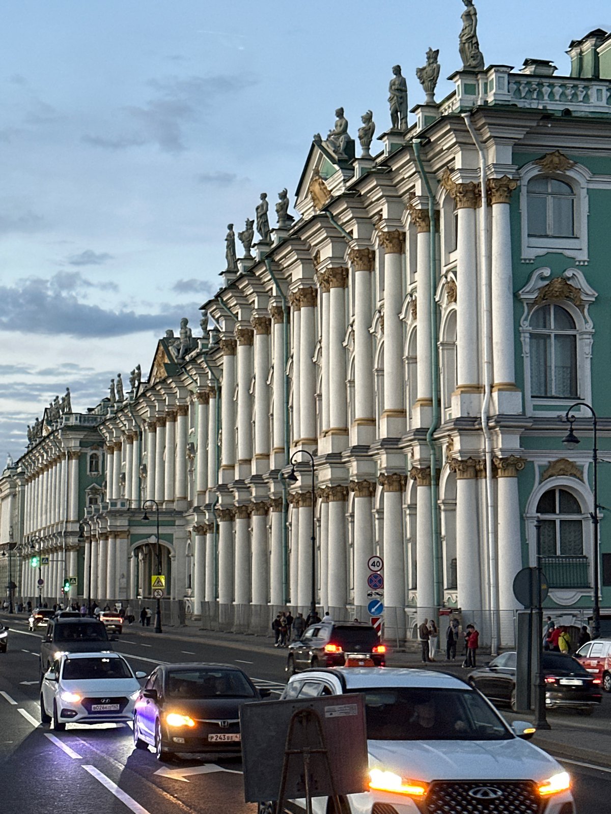 Evening street life near a historic Saint Petersburg landmark