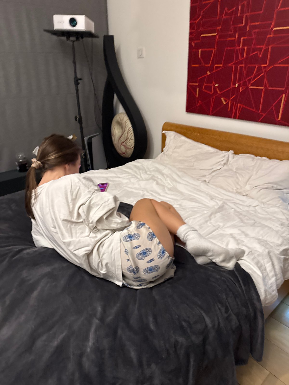 Young woman spends evening on phone in bedroom