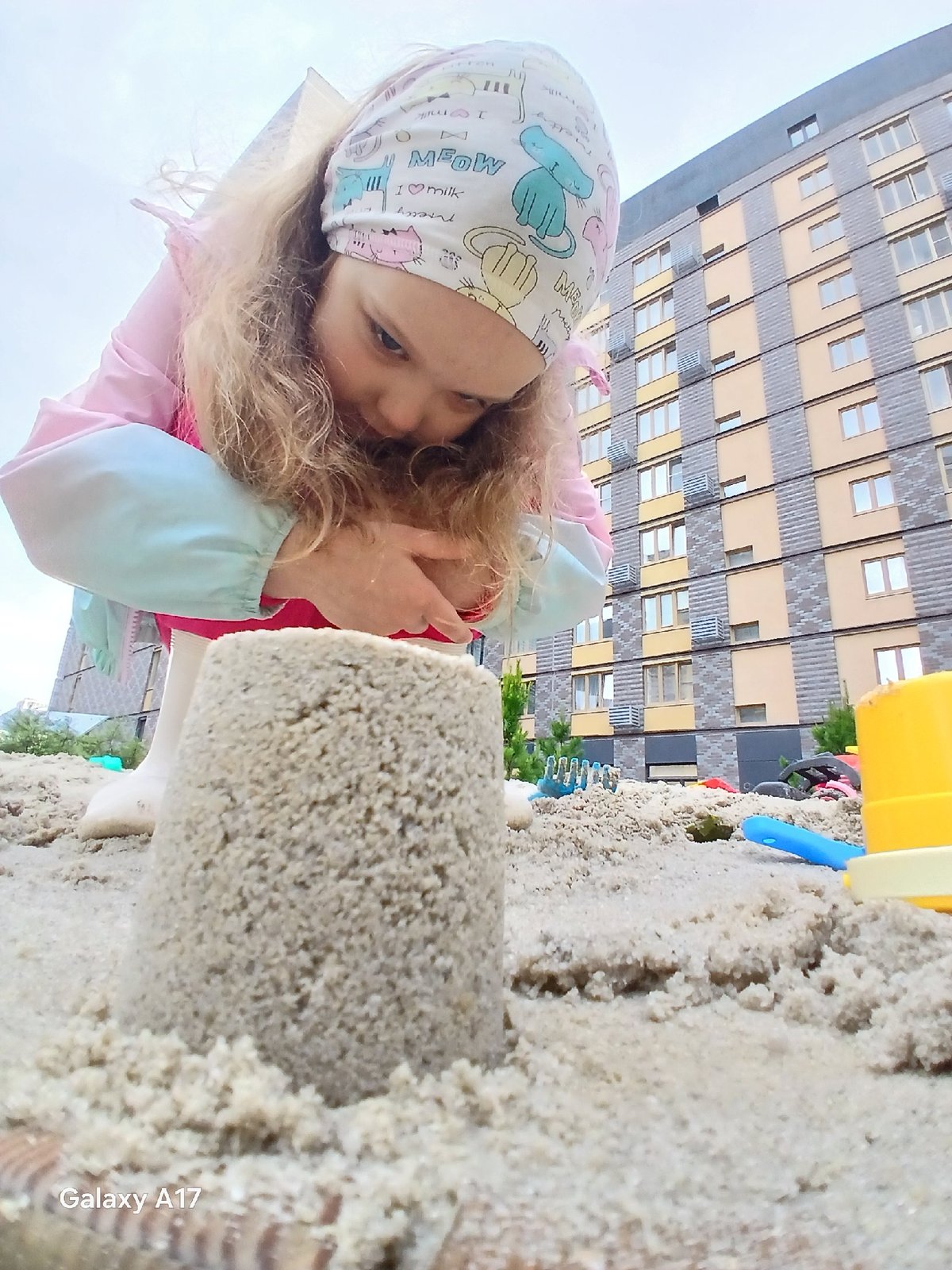 Child plays in sandbox and puddles in Yekaterinburg residential complex