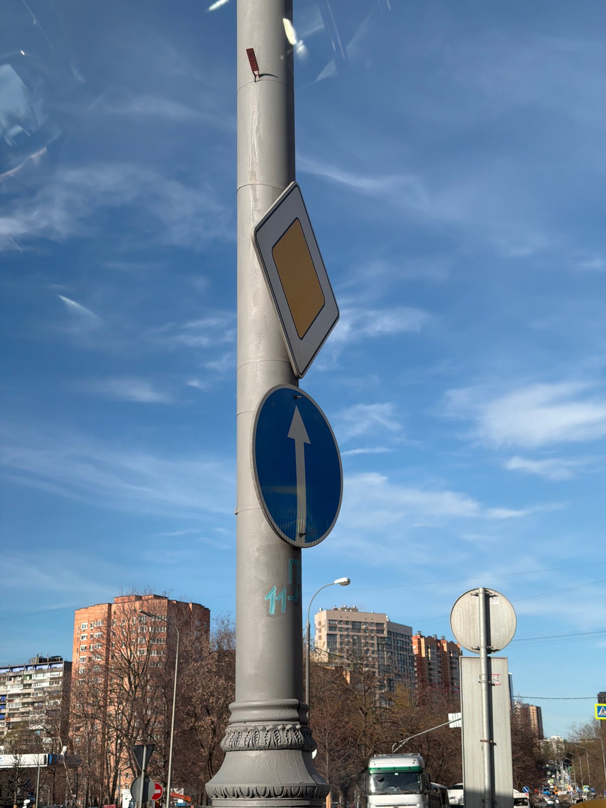 Moscow street scene shows grey pole under blue sky