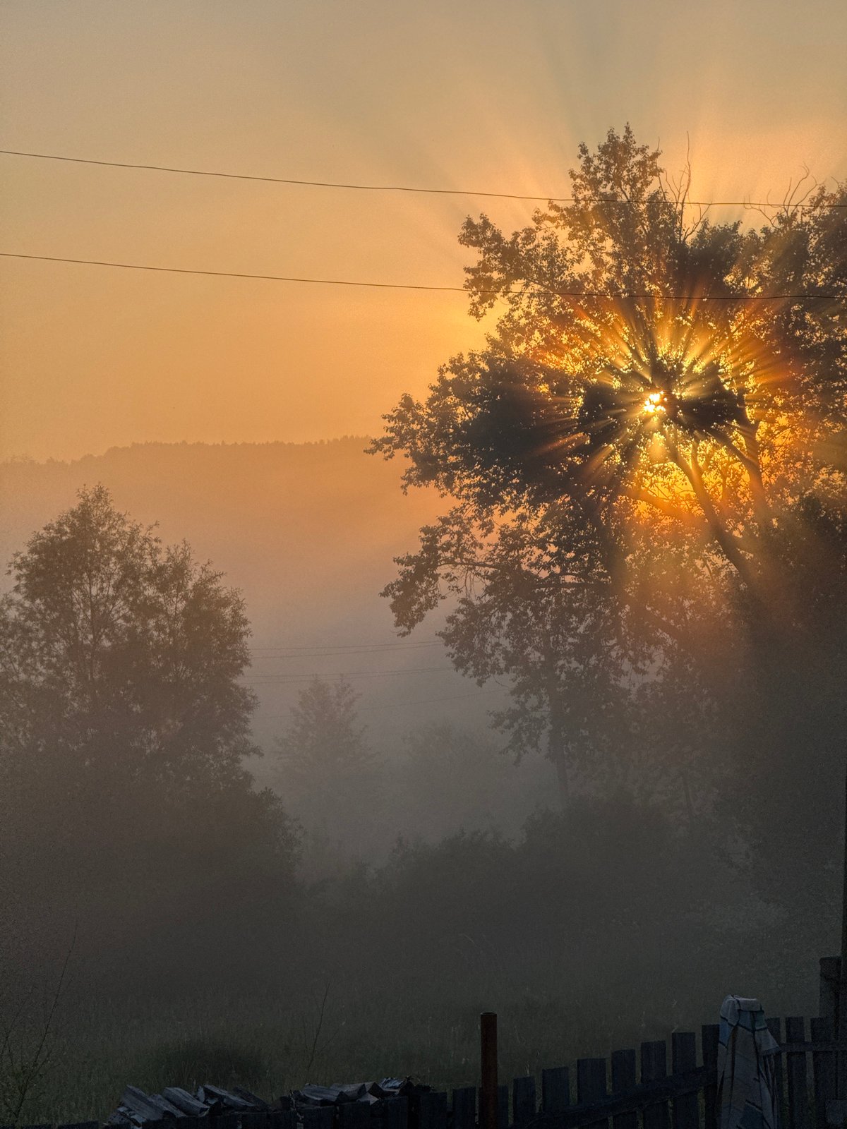 Dawn breaks over misty Russian countryside in Уральское