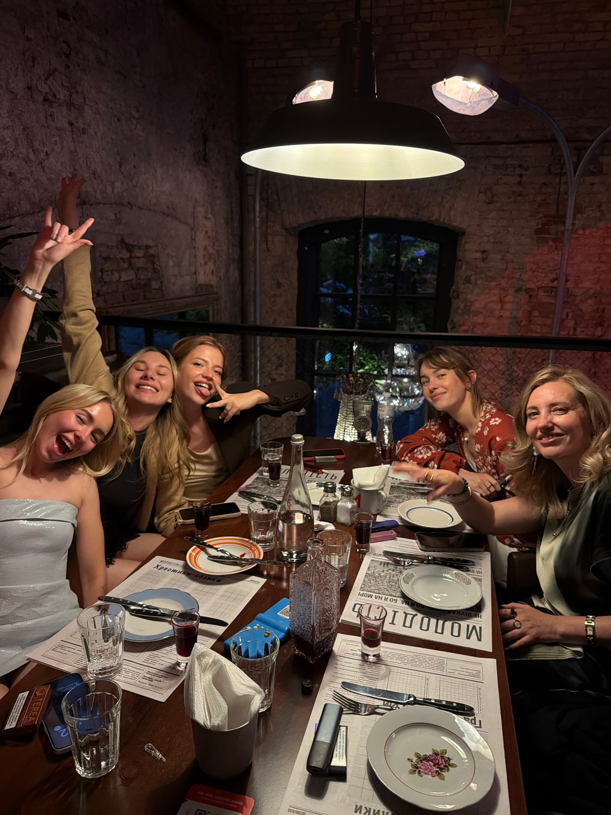 Evening dinner gathering at brick-walled restaurant in Kyiv