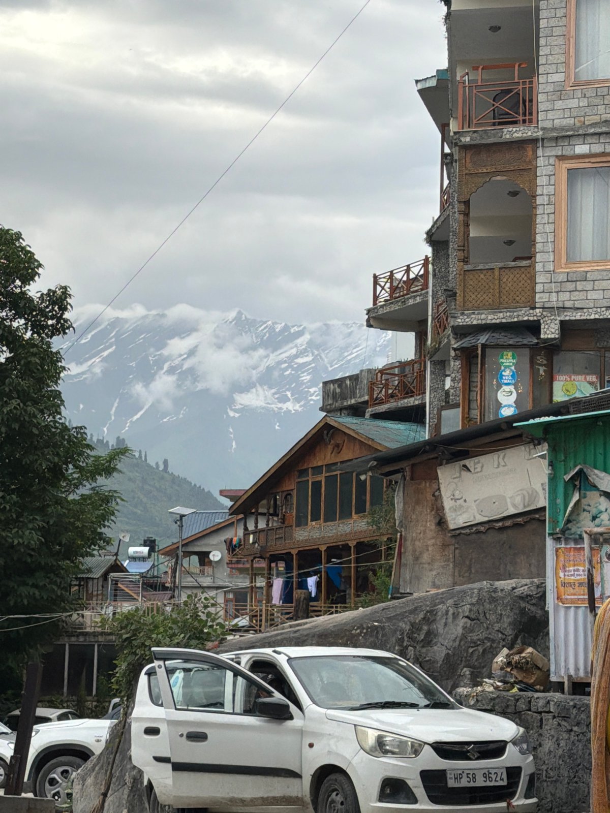 Street life and mountain views in Vashisht on a cloudy July day