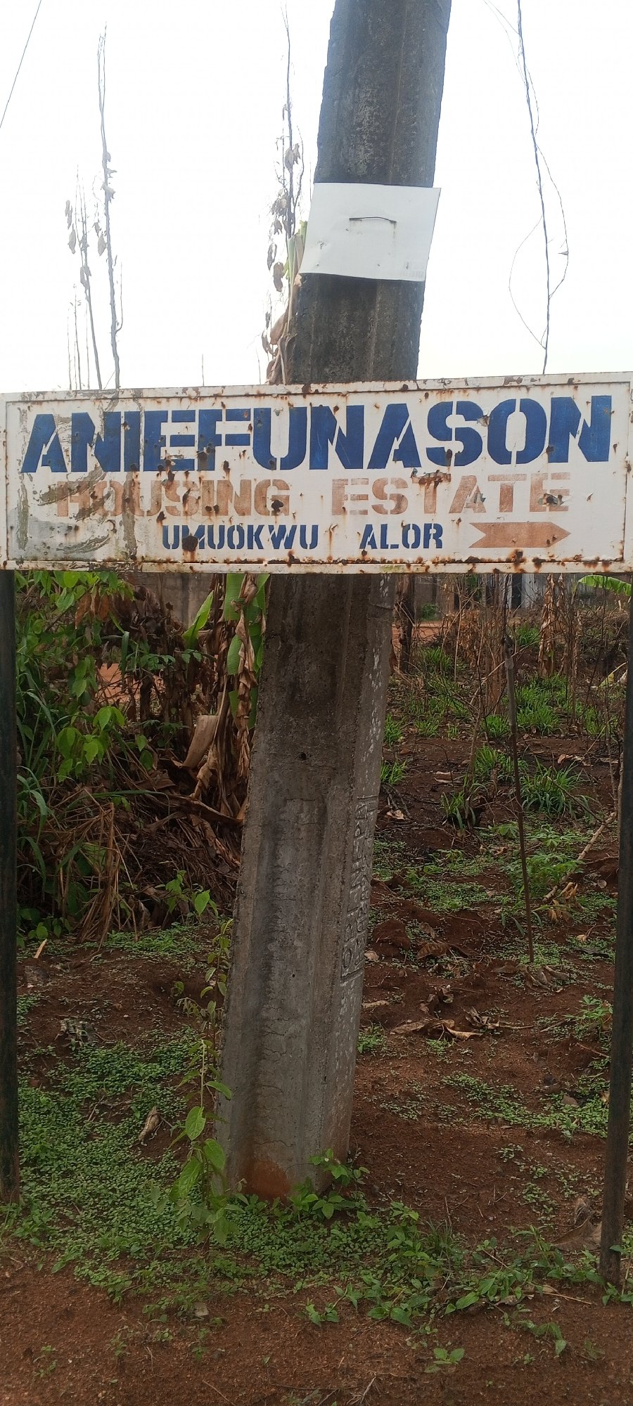 Housing estate signs and pedestrian activity documented in Alor, Nigeria