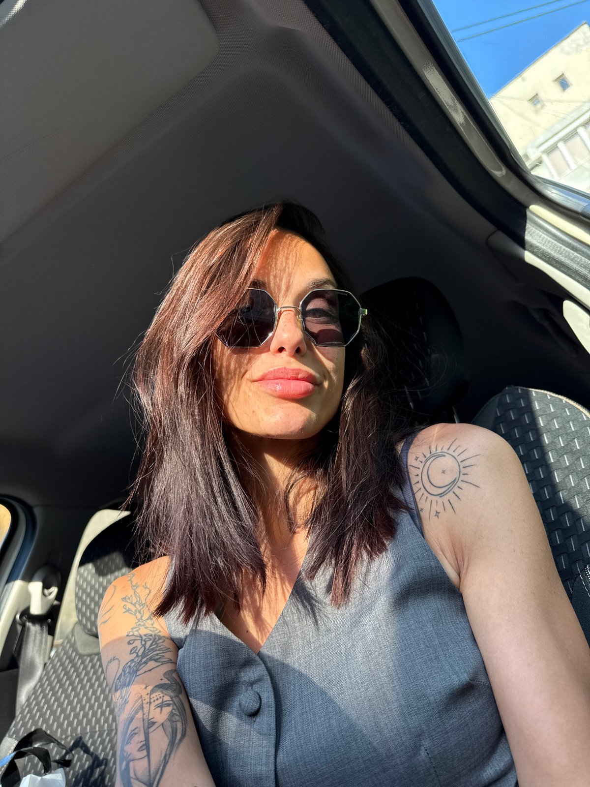 Woman with sun tattoo photographed in car, Pleven Bulgaria