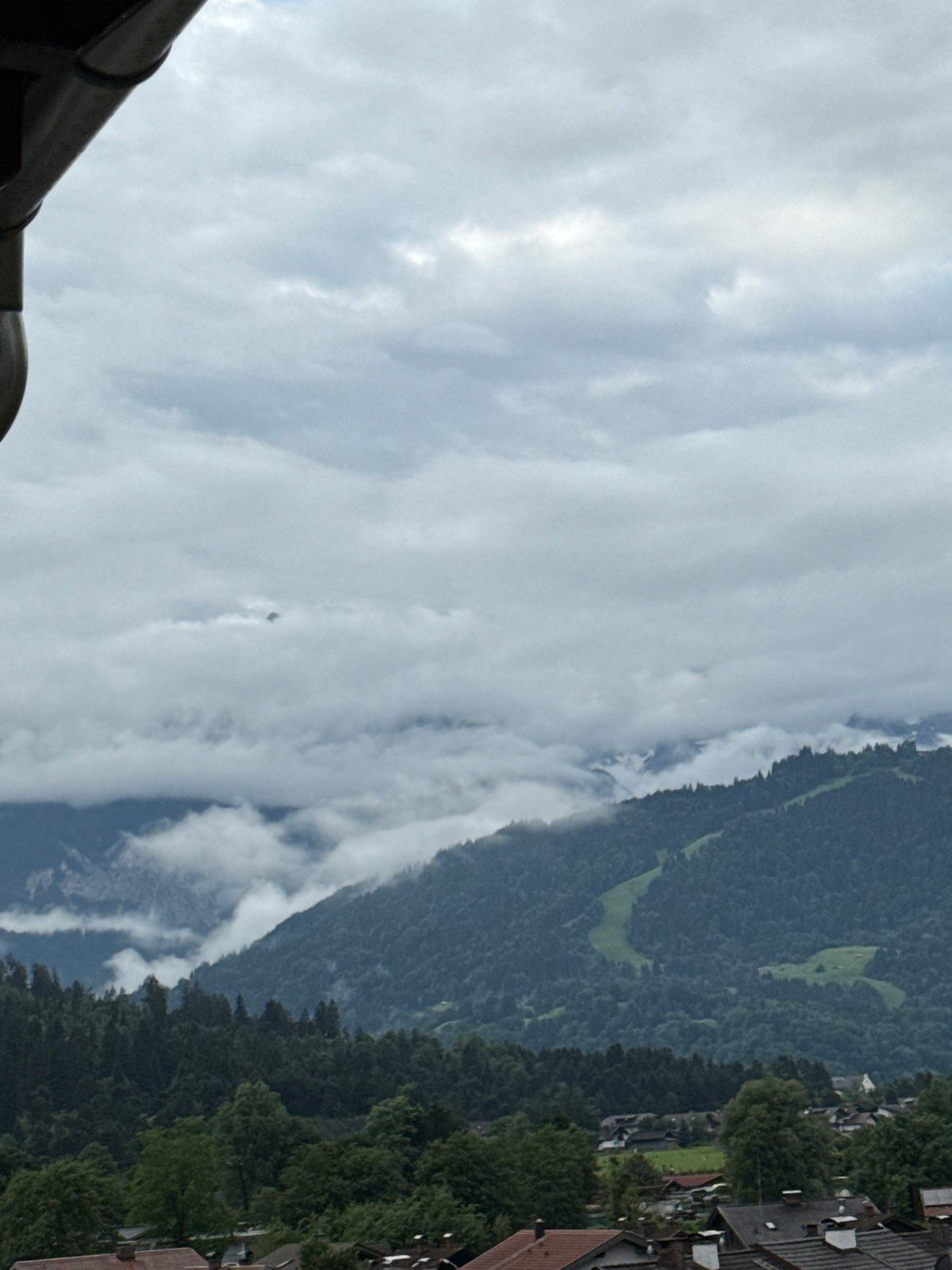 Morning balcony observations capture cloudy Garmisch-Partenkirchen residential mountain views