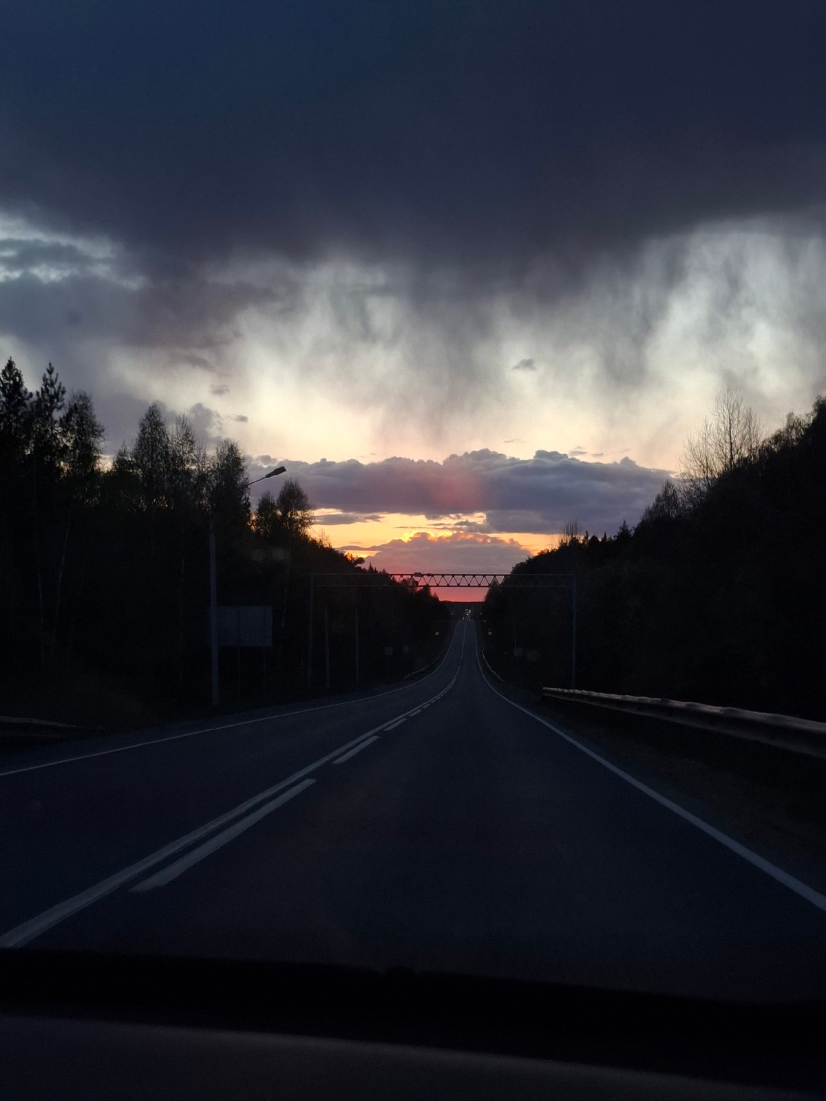 Sunset photograph captures tree-lined road in Chaykovsky, Russia