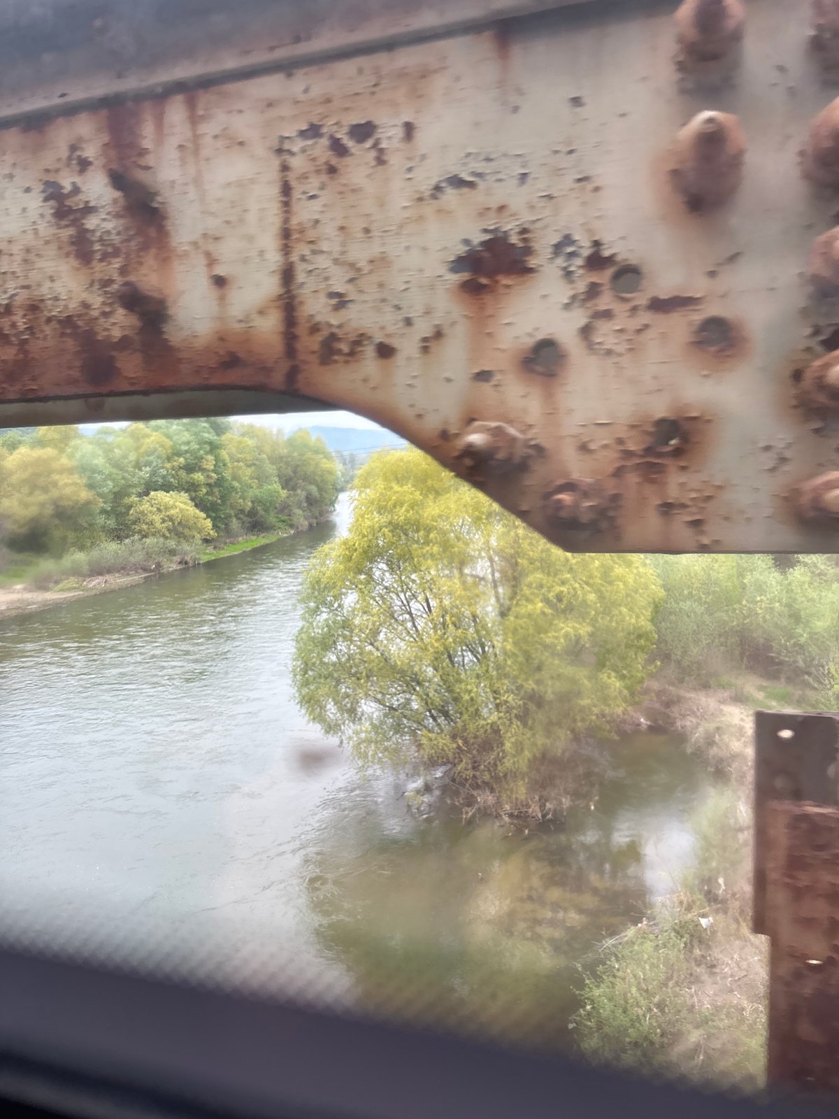 Train journey documented through bridges, stations, and mountain scenery