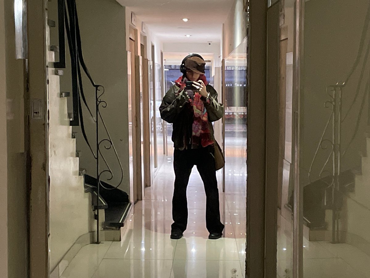 Person documented taking selfies, walking streets in Buenos Aires
