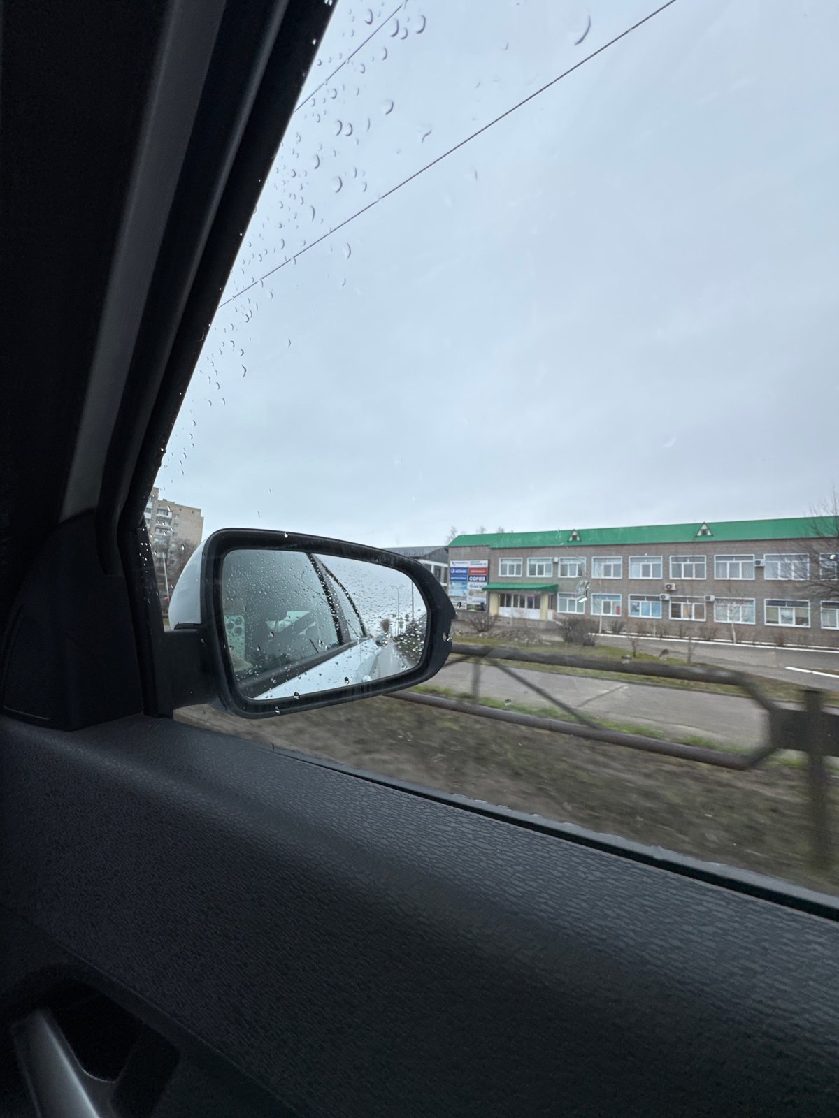 Rainy morning drive captured in car mirror, Chaikovsky Russia