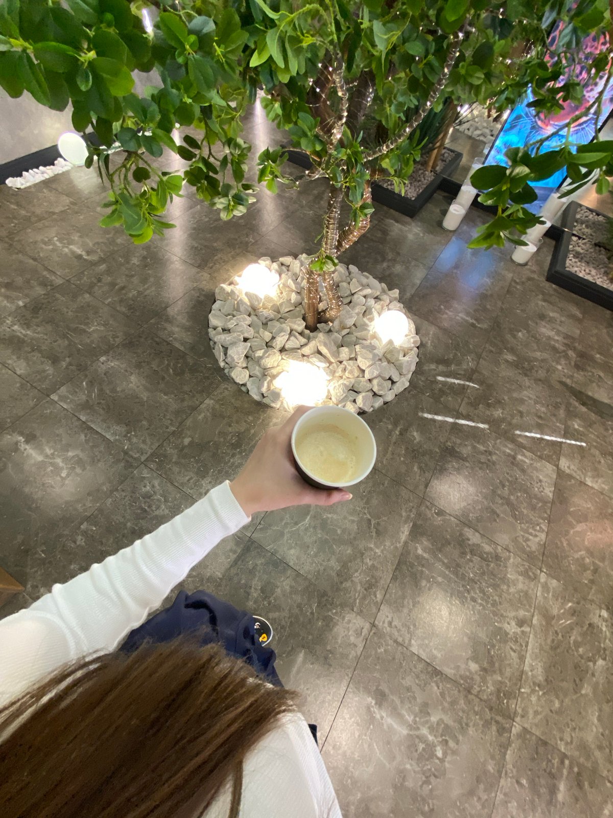 Woman takes morning coffee selfies in Votkinsk interior
