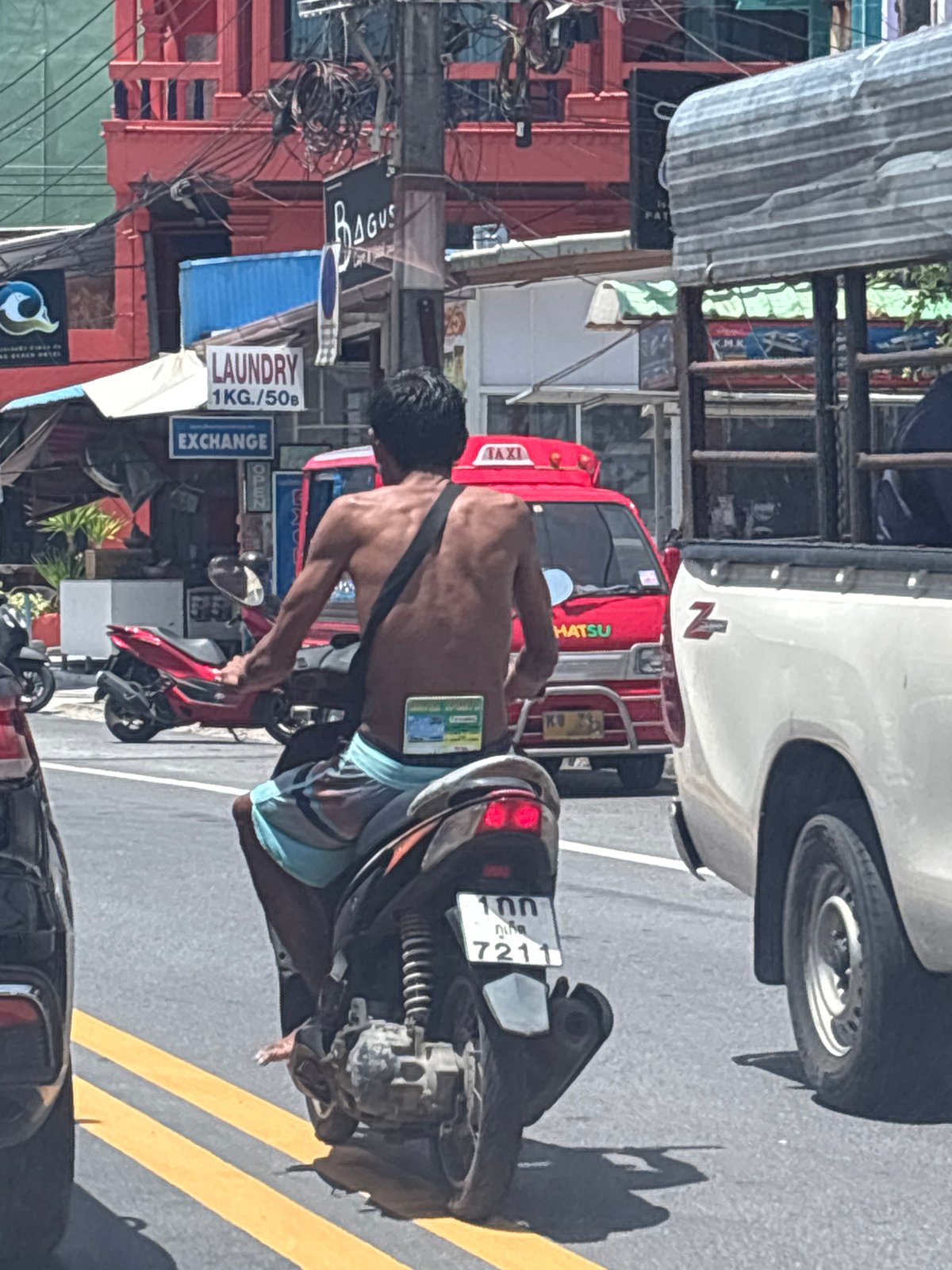 Man spotted on sunny Patong street amid morning traffic
