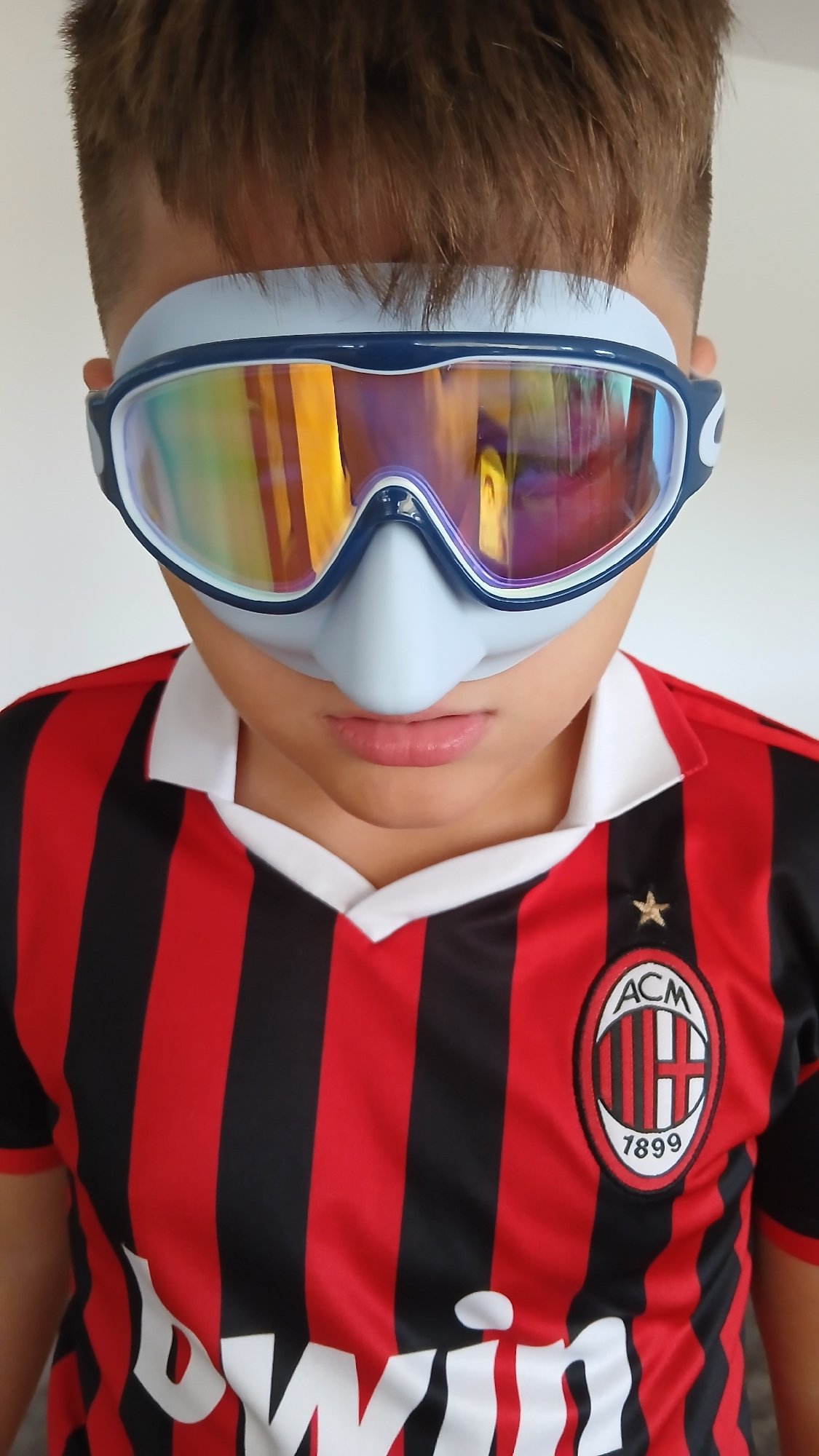 Goggles, diving masks, and a soccer jersey at home