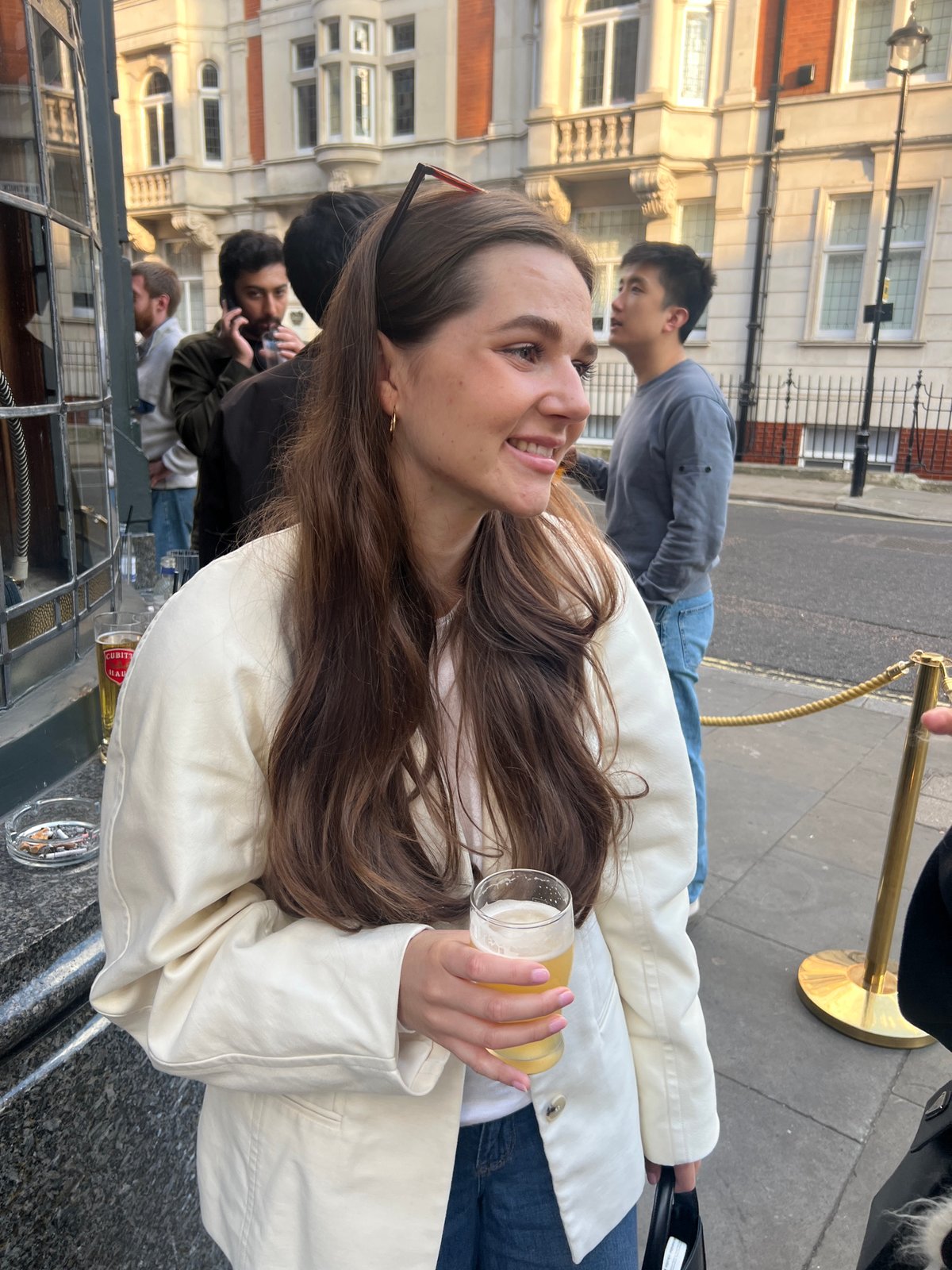 Women toast with beer during evening social gathering in London