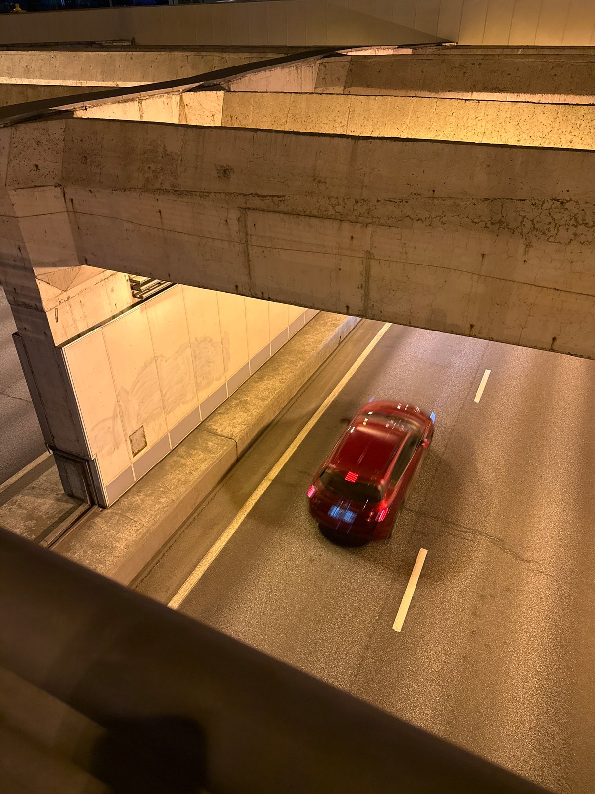 Red car travels on Moscow street from elevated view