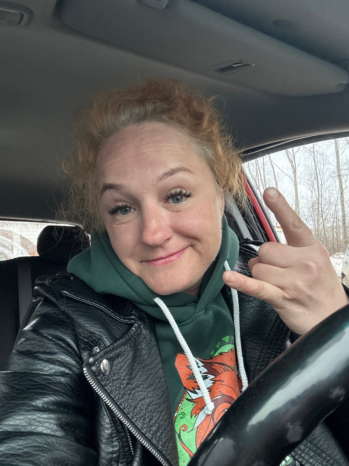 Woman Makes Gestures in Stationary Car During Winter Morning