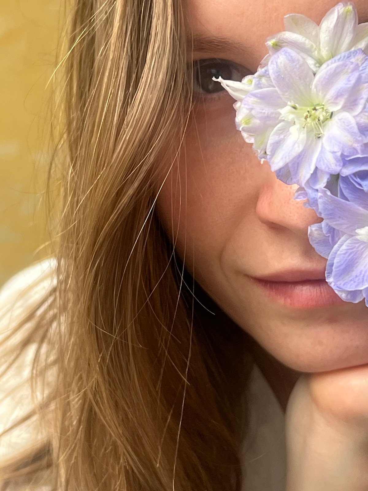 Person photographed with purple flower bouquet in close-up portraits