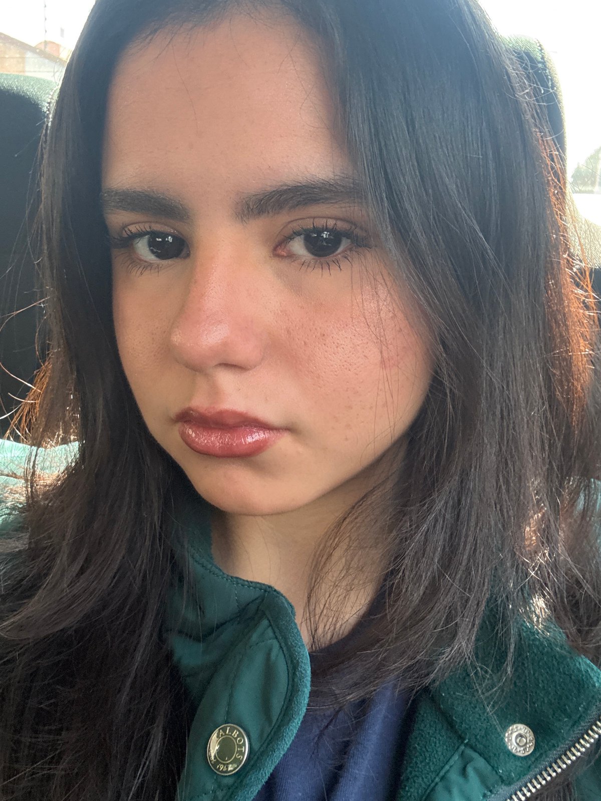 Woman takes selfie in green Talbots jacket in Metepec