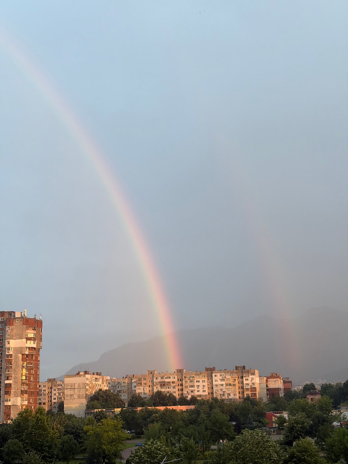 Rainbow over Vratsa's Soviet-era skyline, July evening
