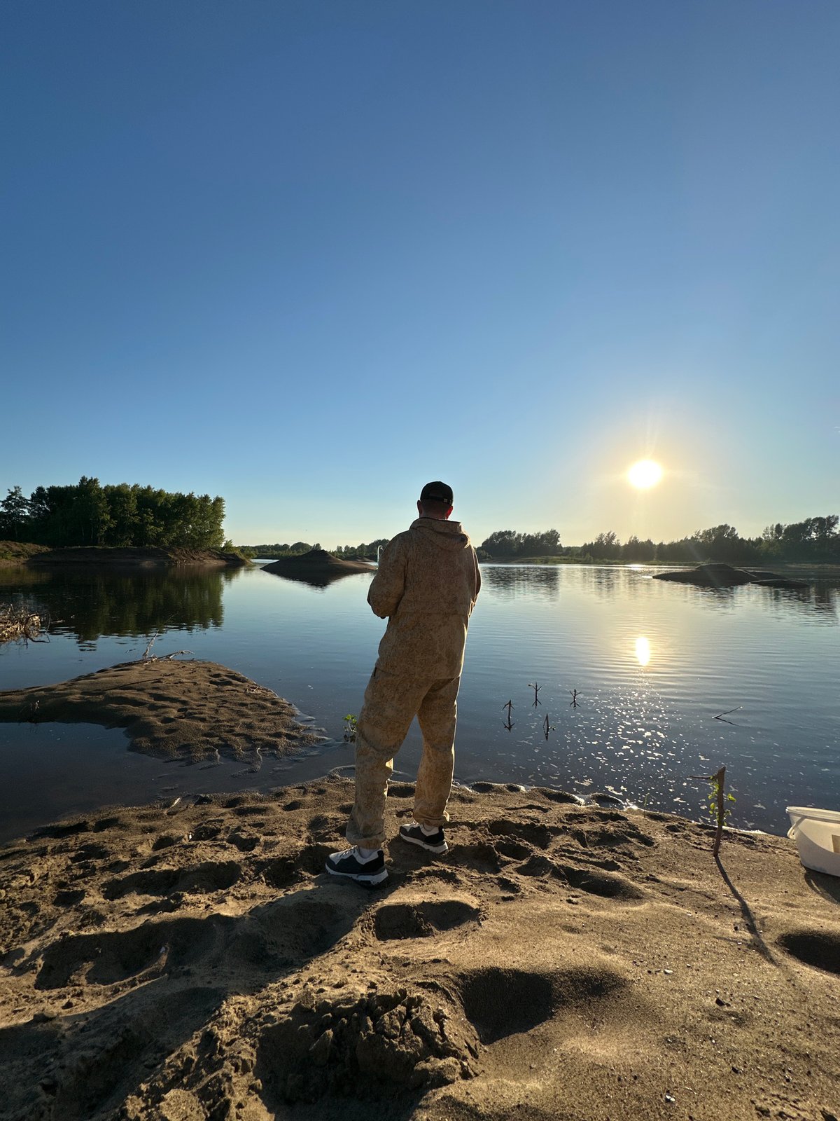 Fishing on a calm Russian riverbank at golden hour