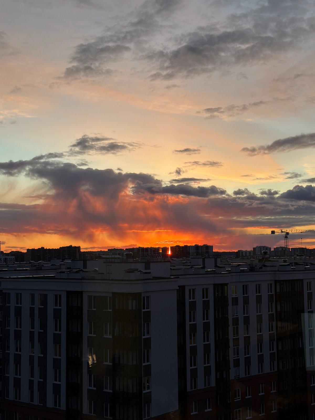 Dramatic sunset illuminates Murino apartment buildings, Russia