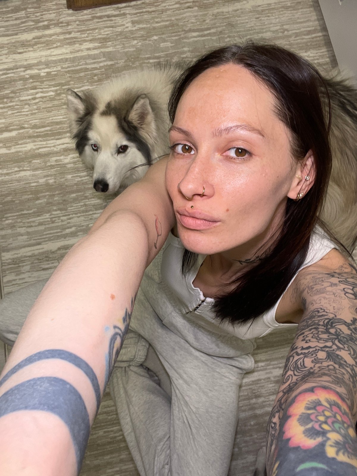 Woman and dog rest together indoors in Izhevsk