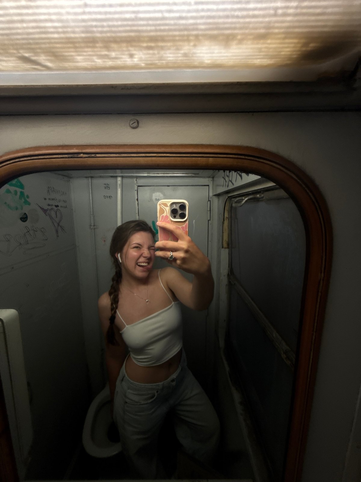 Woman takes mirror selfies in compact space in Serbia