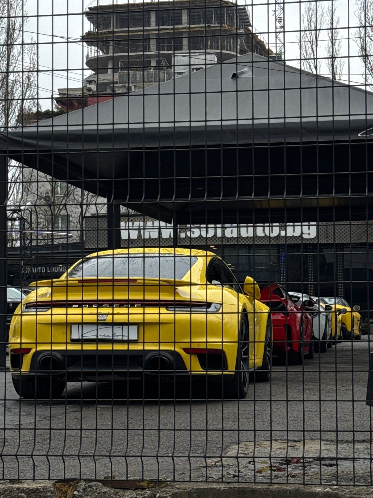Yellow Porsche spotted parked behind fence in Sofia