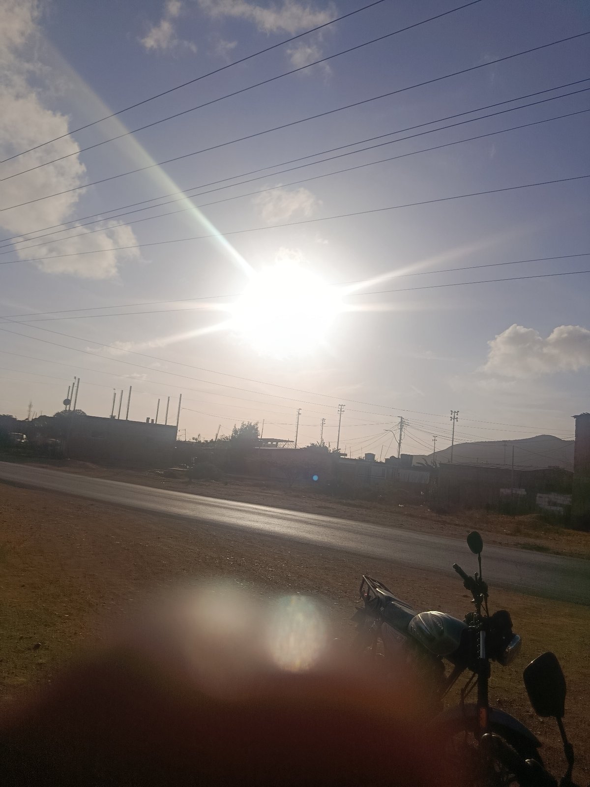 Roadside scenes with motorcycles, vehicles documented in Venezuelan towns