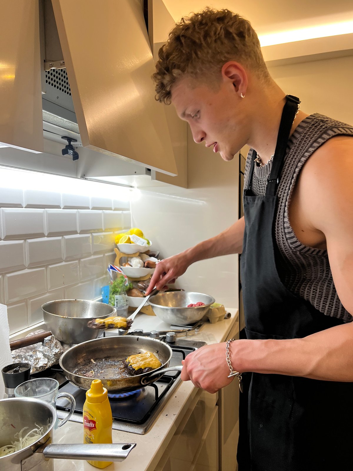 London cook prepares cheeseburgers with fried eggs and fries