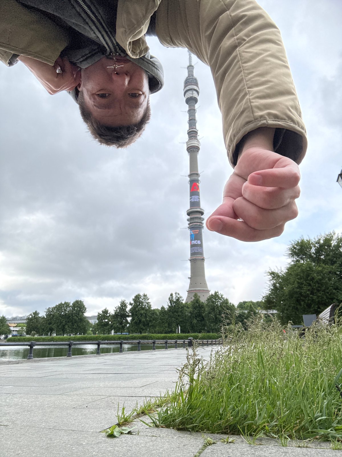 Tourist photographs Ostankino Tower area during early morning visit